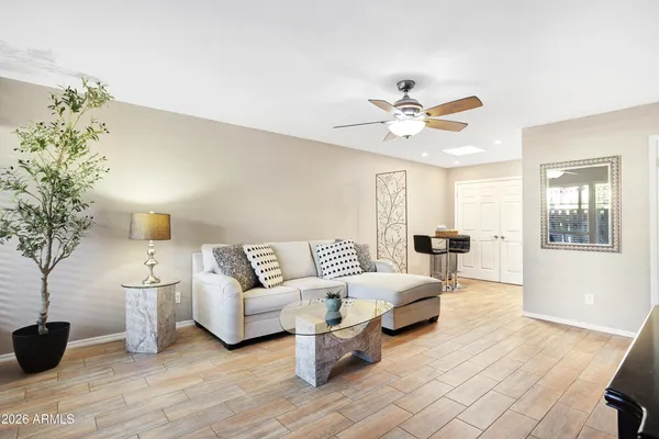 a living room with furniture and a chandelier