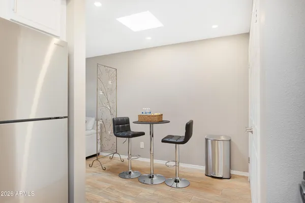 a kitchen with white cabinets and refrigerator