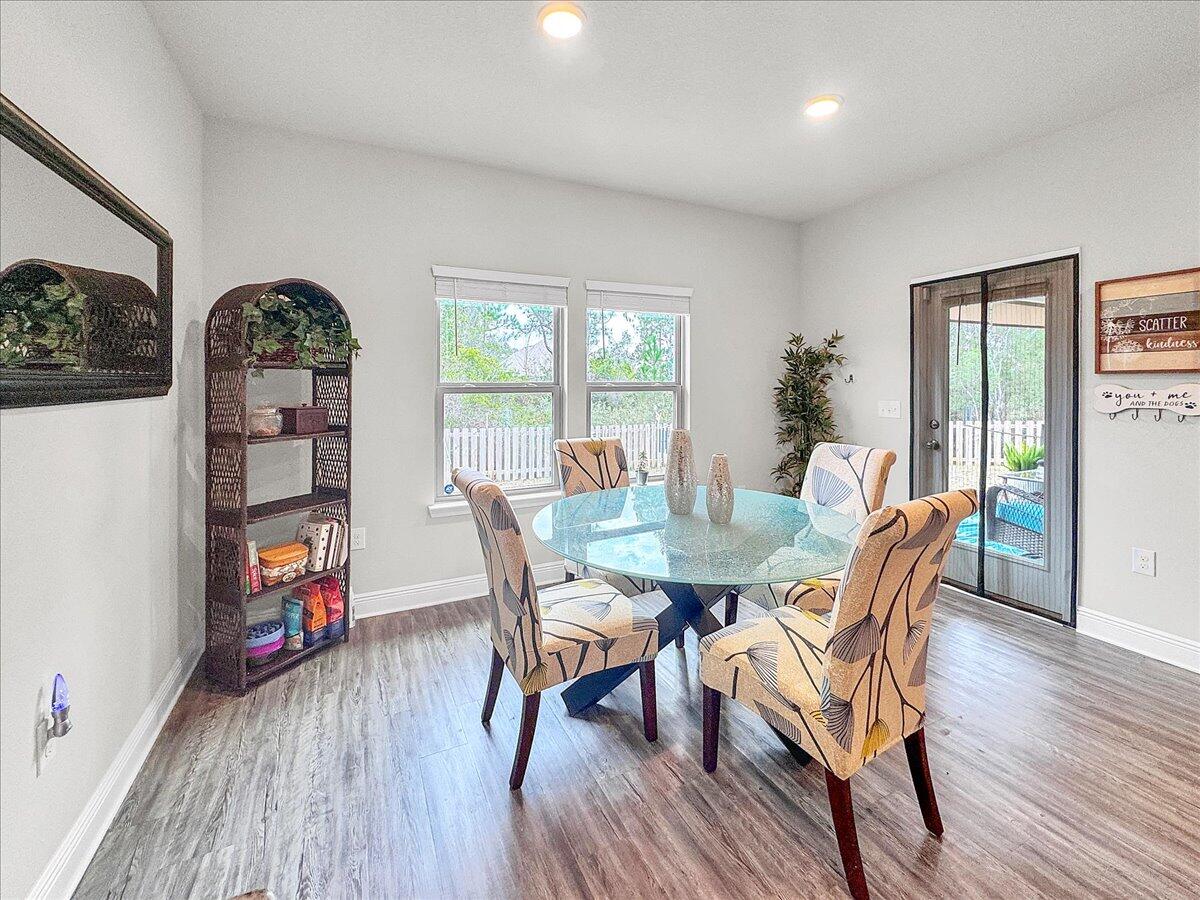 3568 Moonstone Drive Navarre, FL 32566 - Photo 12 of 39 a view of a dining room with furniture window and wooden floor