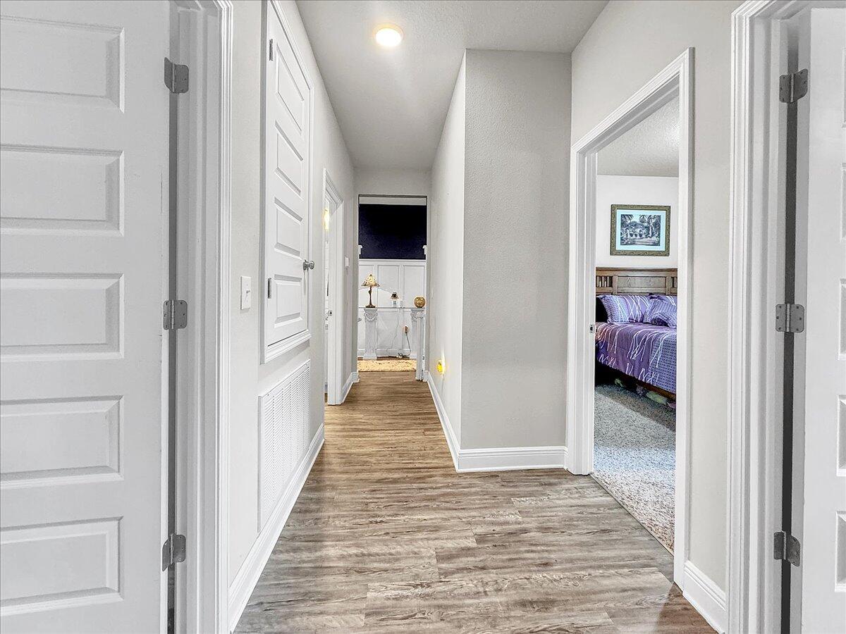 3568 Moonstone Drive Navarre, FL 32566 - Photo 13 of 39 a view of a hallway with bedroom and wooden floor