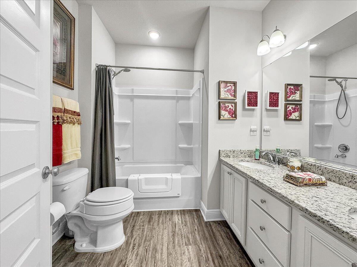 3568 Moonstone Drive Navarre, FL 32566 - Photo 19 of 39 a bathroom with a granite countertop sink toilet tub and shower