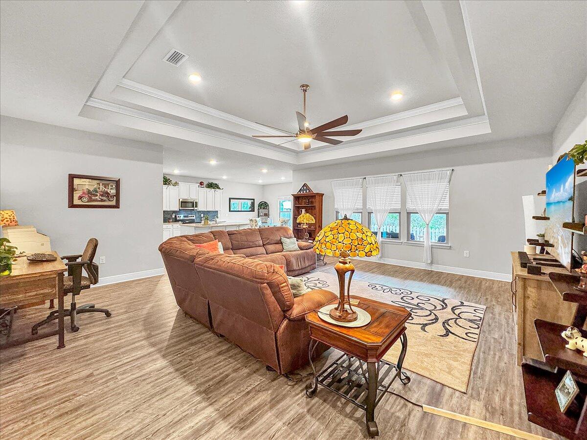 3568 Moonstone Drive Navarre, FL 32566 - Photo 24 of 39 a living room with furniture and a wooden floor