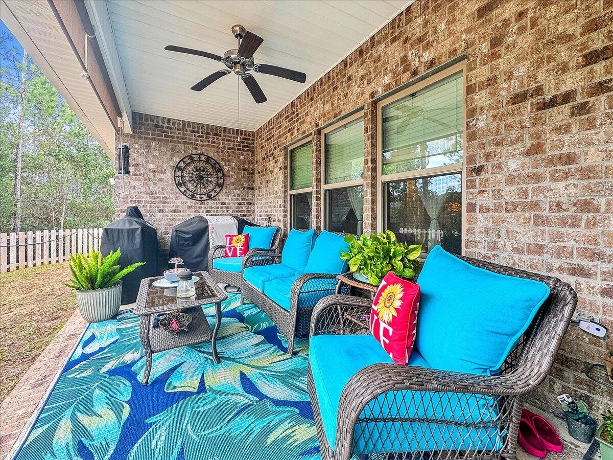 3568 Moonstone Drive Navarre, FL 32566 - Photo 34 of 39 a outdoor living space with furniture fireplace and rug
