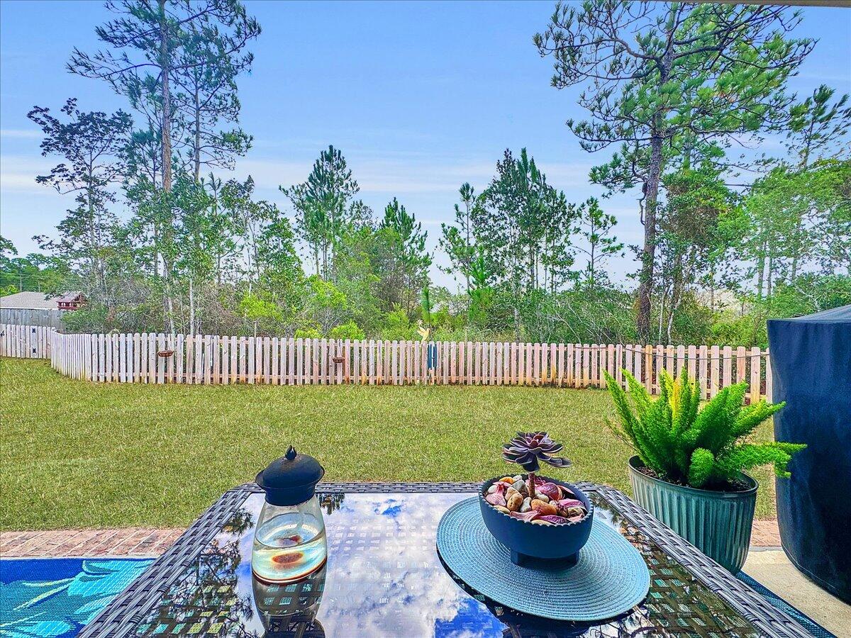 3568 Moonstone Drive Navarre, FL 32566 - Photo 35 of 39 a balcony with potted plants and a bench