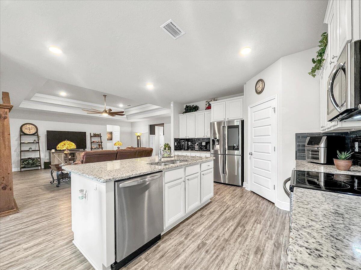 3568 Moonstone Drive Navarre, FL 32566 - Photo 10 of 39 a kitchen with stainless steel appliances granite countertop a sink and cabinets
