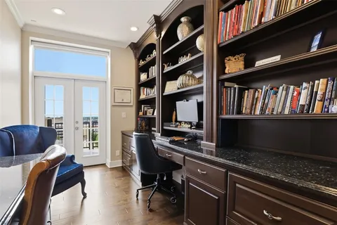 a view of a workspace with furniture and a book shelf