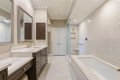 a spacious bathroom with a tub sink and mirror