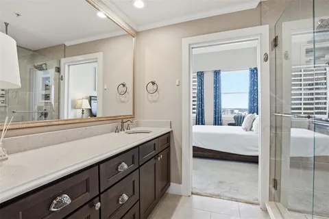 a bathroom with a tub a double vanity sink and mirror