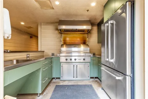 a kitchen with a refrigerator and a sink