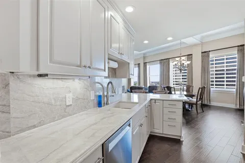 a kitchen with sink cabinets and wooden floor