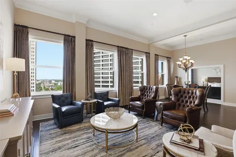 a living room with furniture a window and a dining table