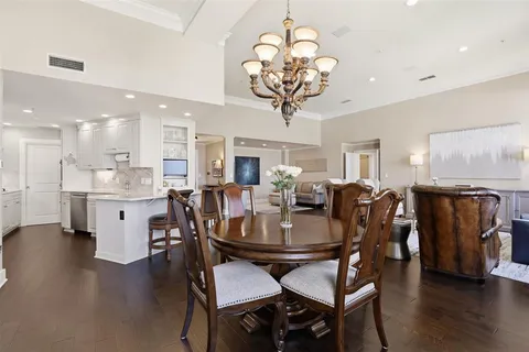 a view of a dining room with furniture wooden floor and chandelier