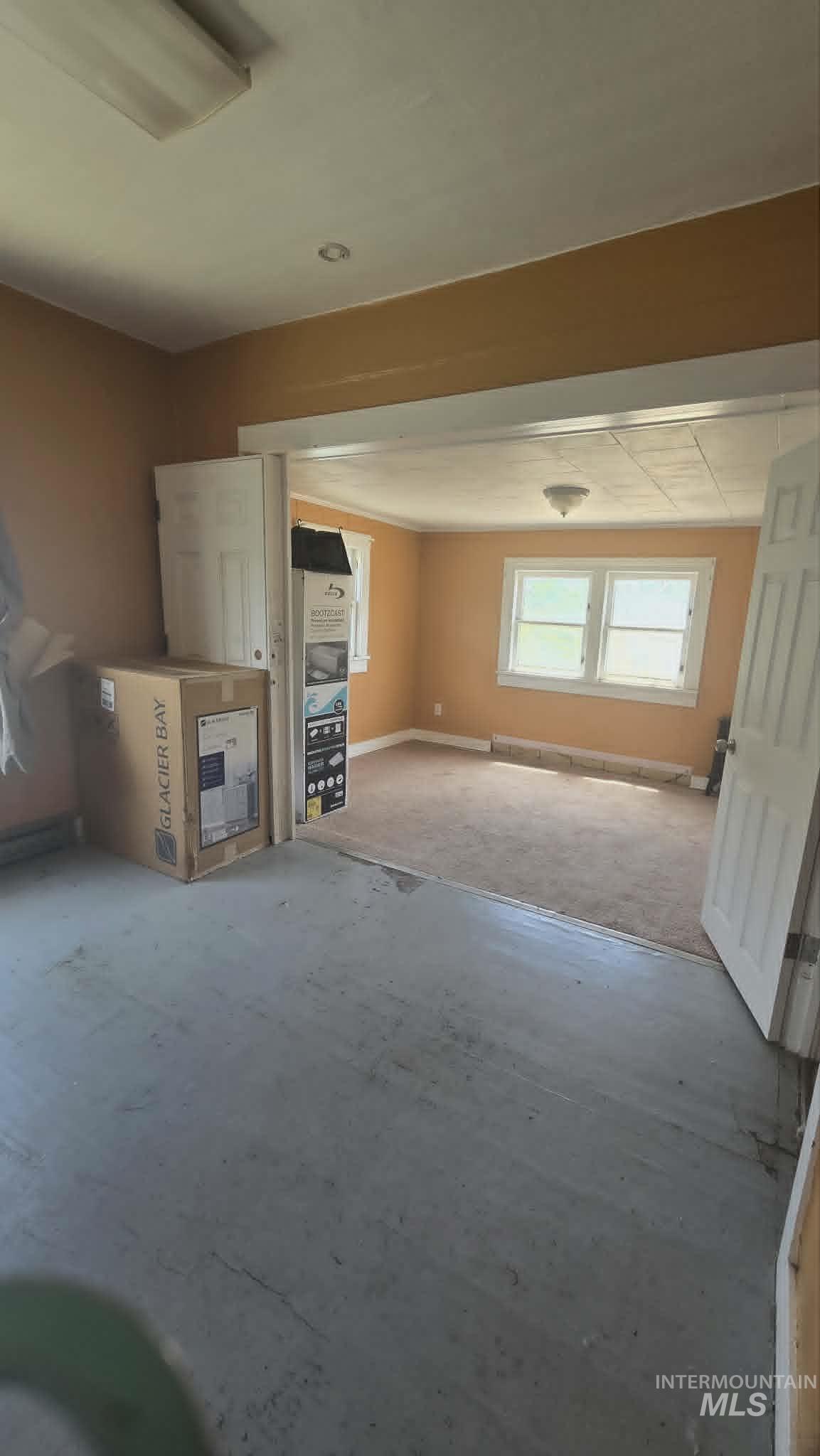 1212 Main Street Pomeroy, WA 99347 - Photo 10 of 18 Room featuring painted concrete flooring, a wide doorway, and a ceiling-mounted light fixture