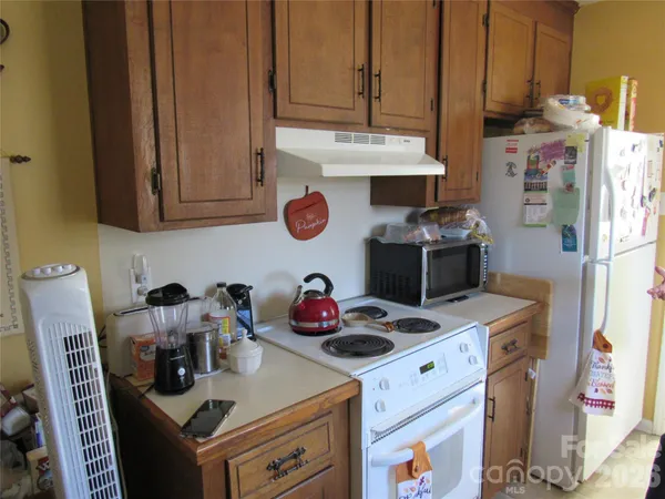 a kitchen with stainless steel appliances granite countertop a stove and a refrigerator