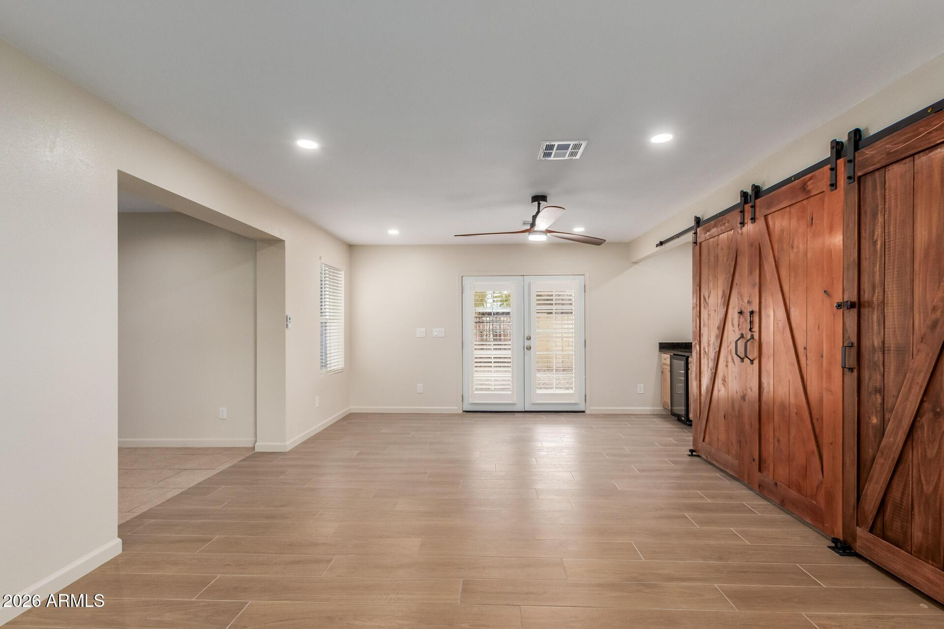 1628 East Del Rio Drive Tempe, AZ 85282 - Photo 3 of 32 an empty room with wooden floor and stairs