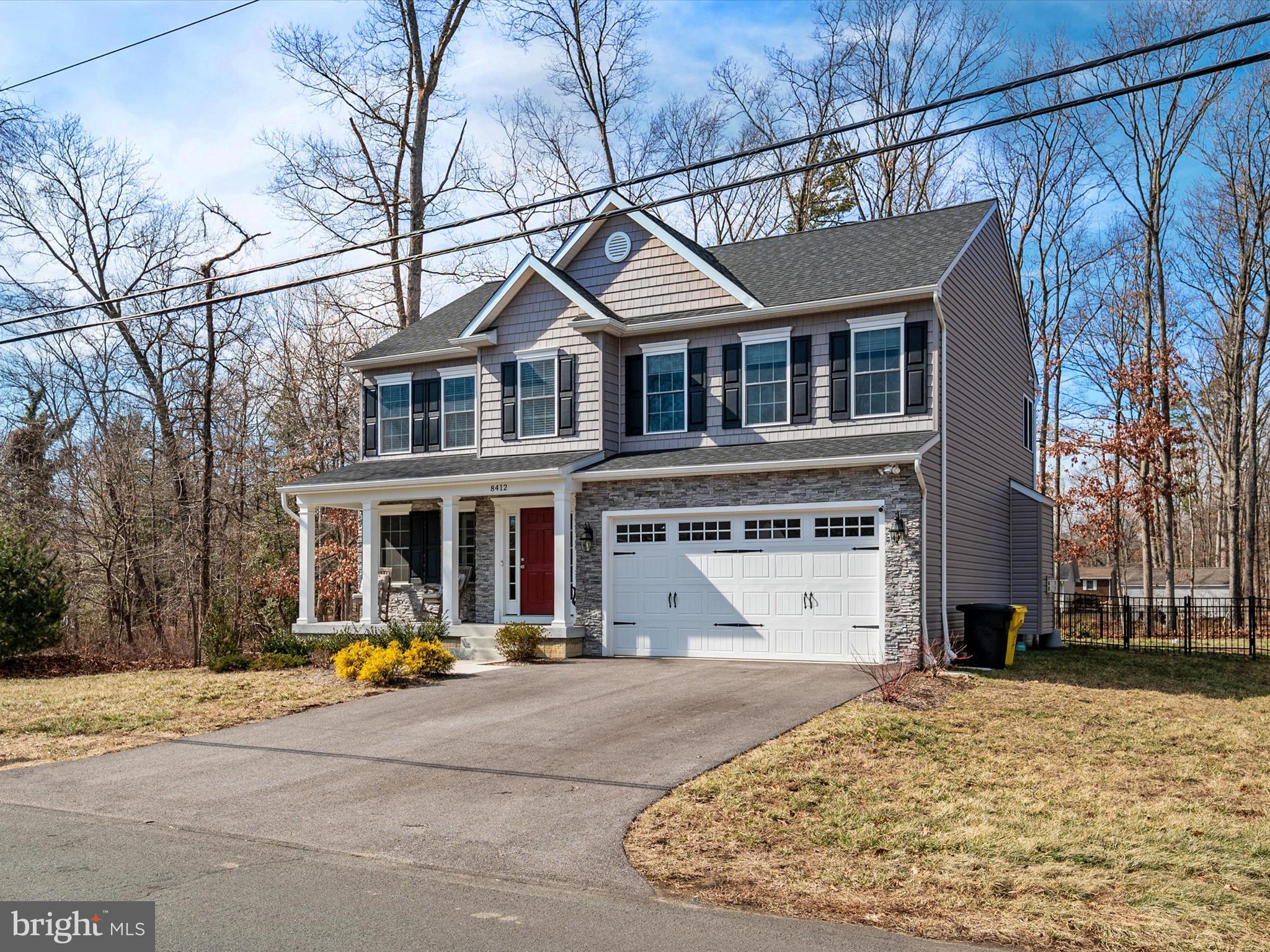 8412 Maryland Road Pasadena, MD 21122 - Photo 2 of 61 a view of a white house with a large tree in front of it