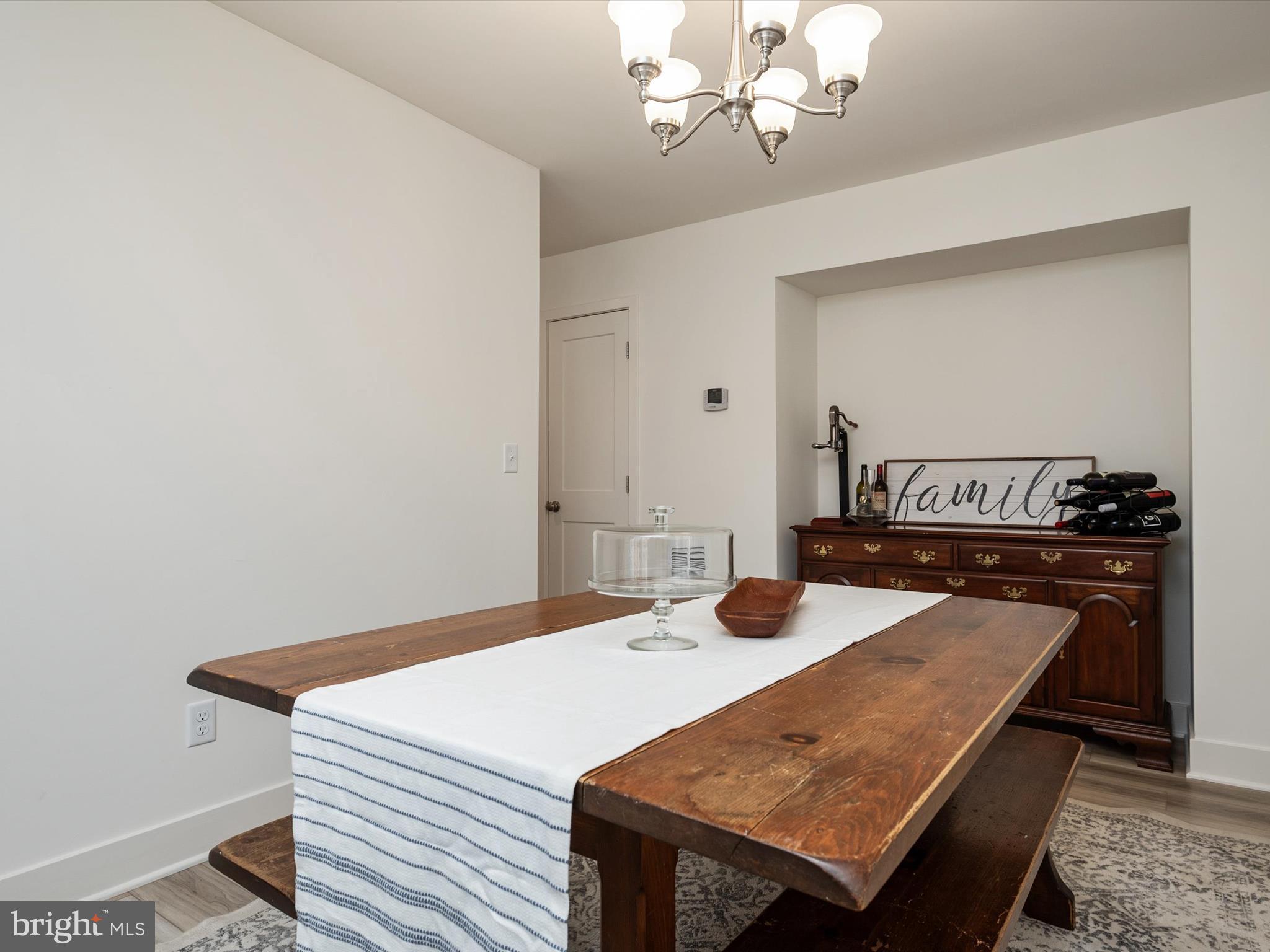 8412 Maryland Road Pasadena, MD 21122 - Photo 26 of 61 a view of a dining room with furniture and wooden floor