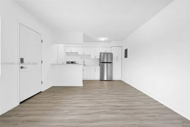 a kitchen with stainless steel appliances a refrigerator sink and microwave