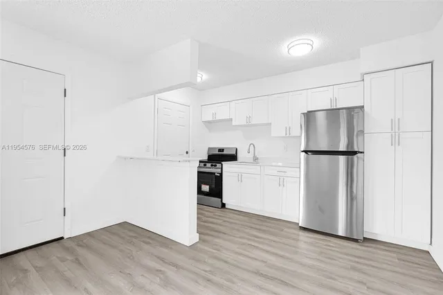 a kitchen with a stove and a microwave