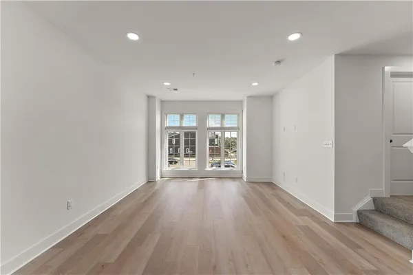 wooden floor in an empty room with a window