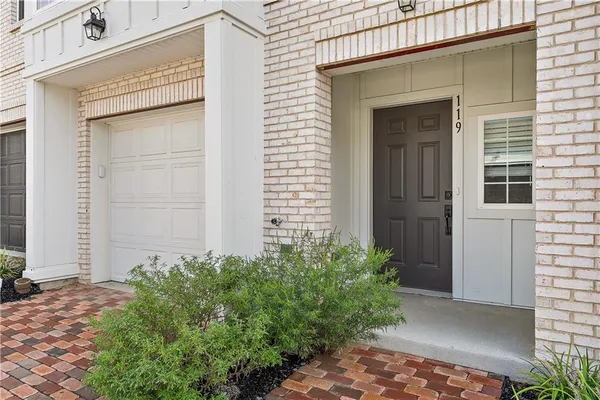 a view of a house with potted plants