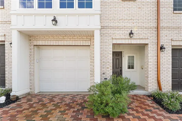 a view of a house with potted plants