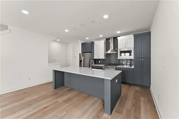a kitchen with a sink cabinets stainless steel appliances and counter space
