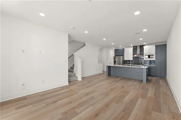a view of kitchen with kitchen island and stainless steel appliances