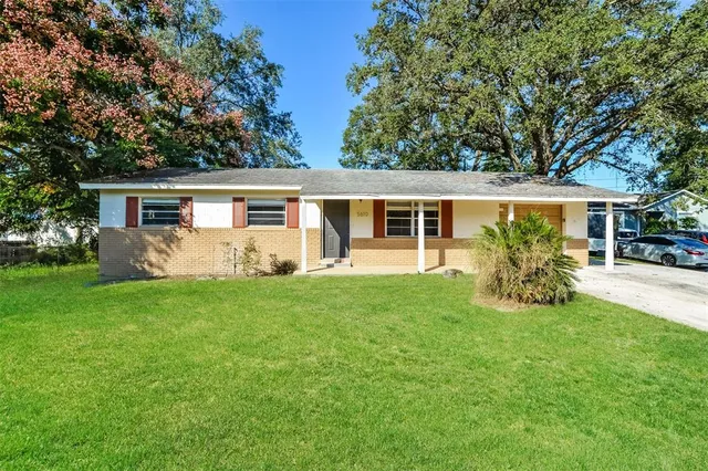 a view of a house with backyard sitting area and garden
