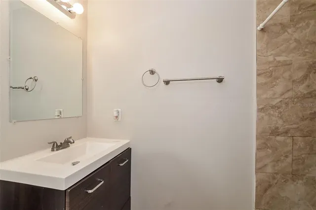 a bathroom with a sink mirror and vanity