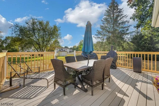 a view of a deck with table and chairs and wooden floor