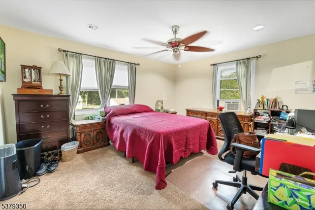 a spacious bedroom with a bed and wooden floor