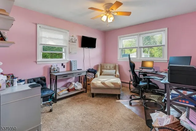 a living room with furniture a flat screen tv and a window