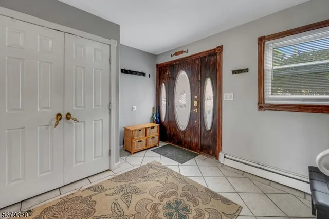 a view of an entryway with a table and a mirror