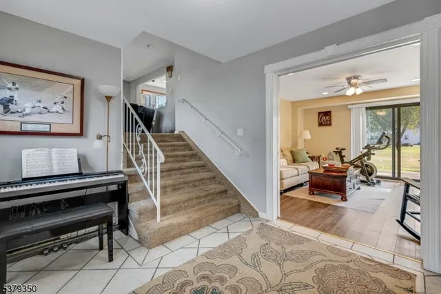 a living room with furniture and a piano