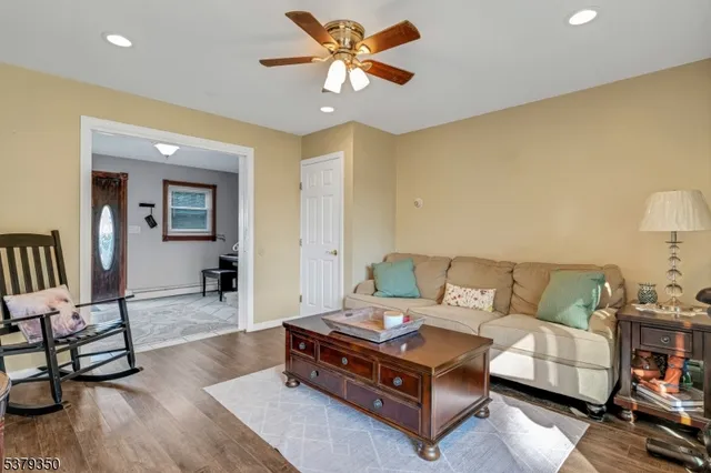 a living room with furniture and wooden floor
