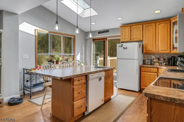 a kitchen with refrigerator cabinets and wooden floor