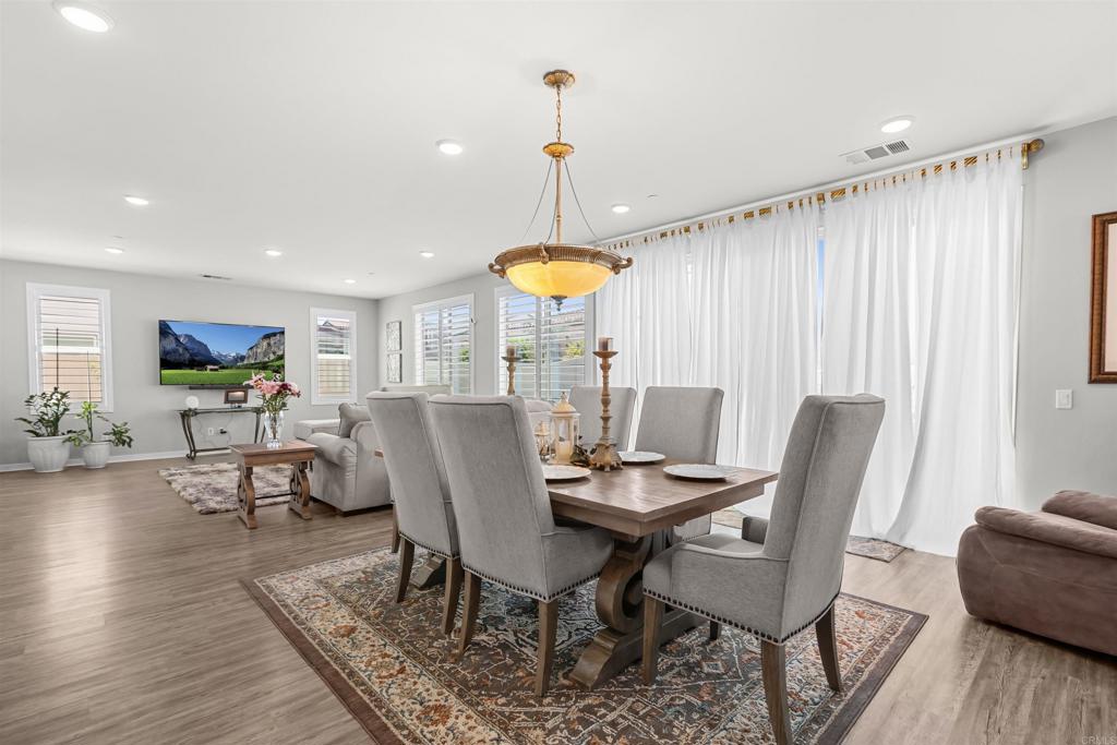 29809 Gypsy Vanner Way Menifee, CA 92584 - Photo 16 of 45 a view of a dining room with furniture and wooden floor