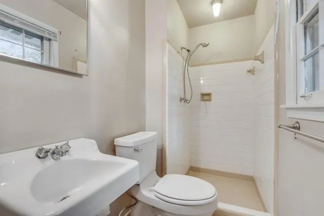 a white toilet sitting next to a bathroom sink
