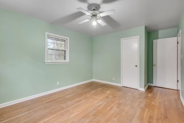 wooden floor in an empty room with a window