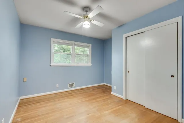a view of a room with a ceiling fan and a window