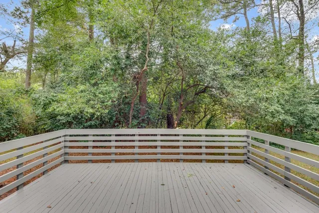 a view of backyard with deck and trees