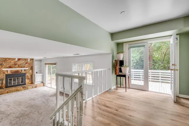 a view of a hallway with furniture and chandelier