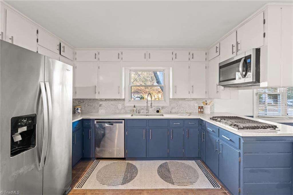 1430 Eldorada Road Winston-Salem, NC 27103 - Photo 11 of 45 Restored Kitchen with gas range, wall oven, solid surface countertops, tiled backsplash and under mount sink