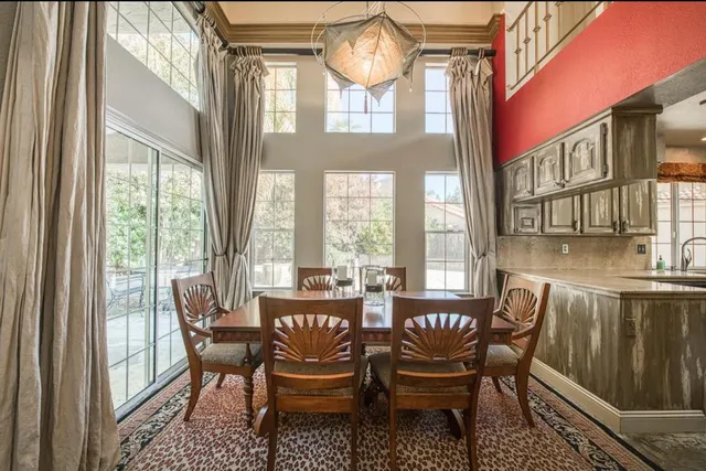 a dining room with furniture a rug and wooden floor