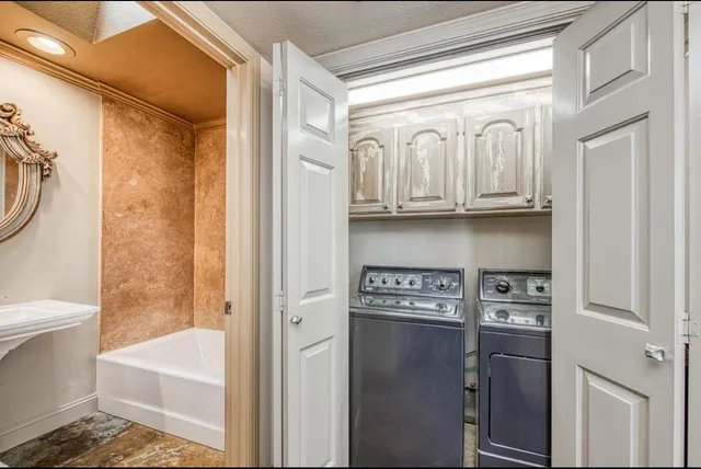 a bathroom with a tub a toilet and a shower