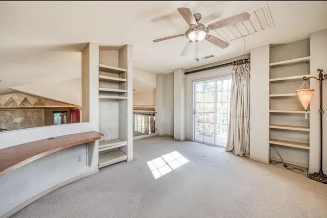 a view of workspace with window and a ceiling fan