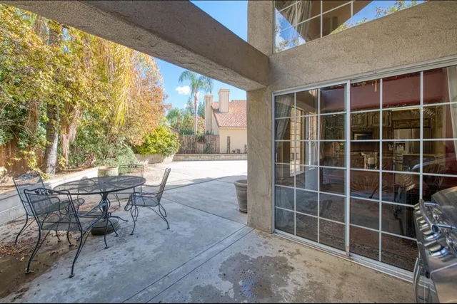 a view of a tables and chairs and table in the backyard