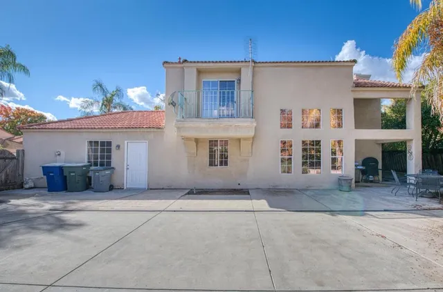 a view of a house with a patio and a garage