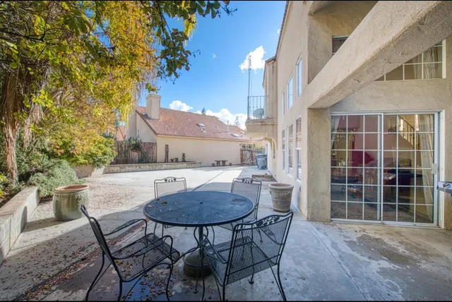 a view of a dining room with furniture and a potted plant